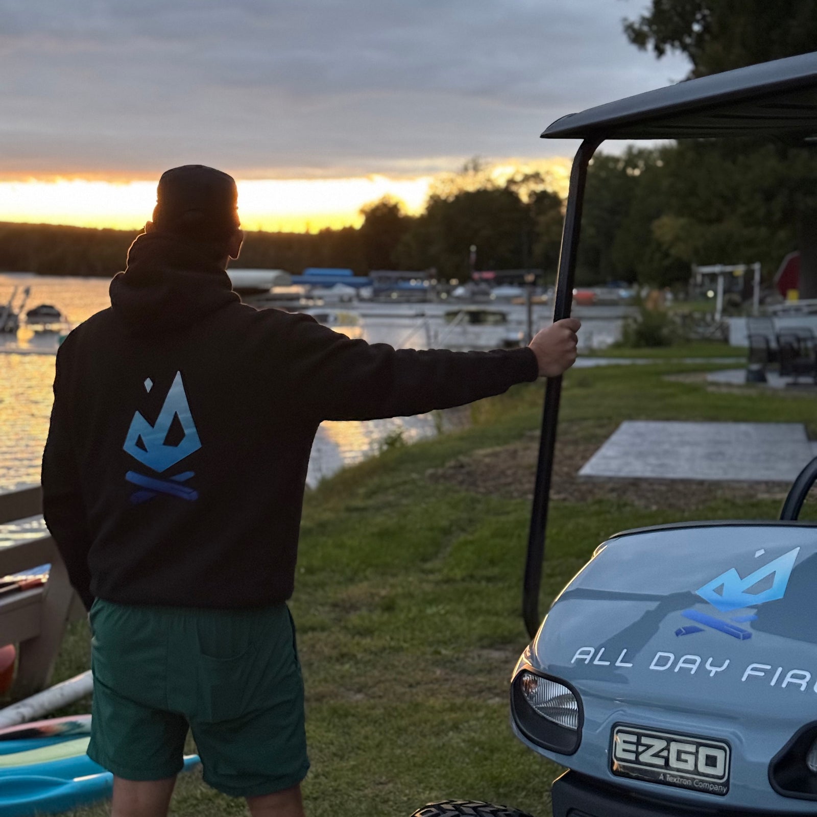 Back: Black hoodie featuring large blue All Day Fire Outfitters flame logo on the back. Outdoor hoodie built for comfort and adventure.