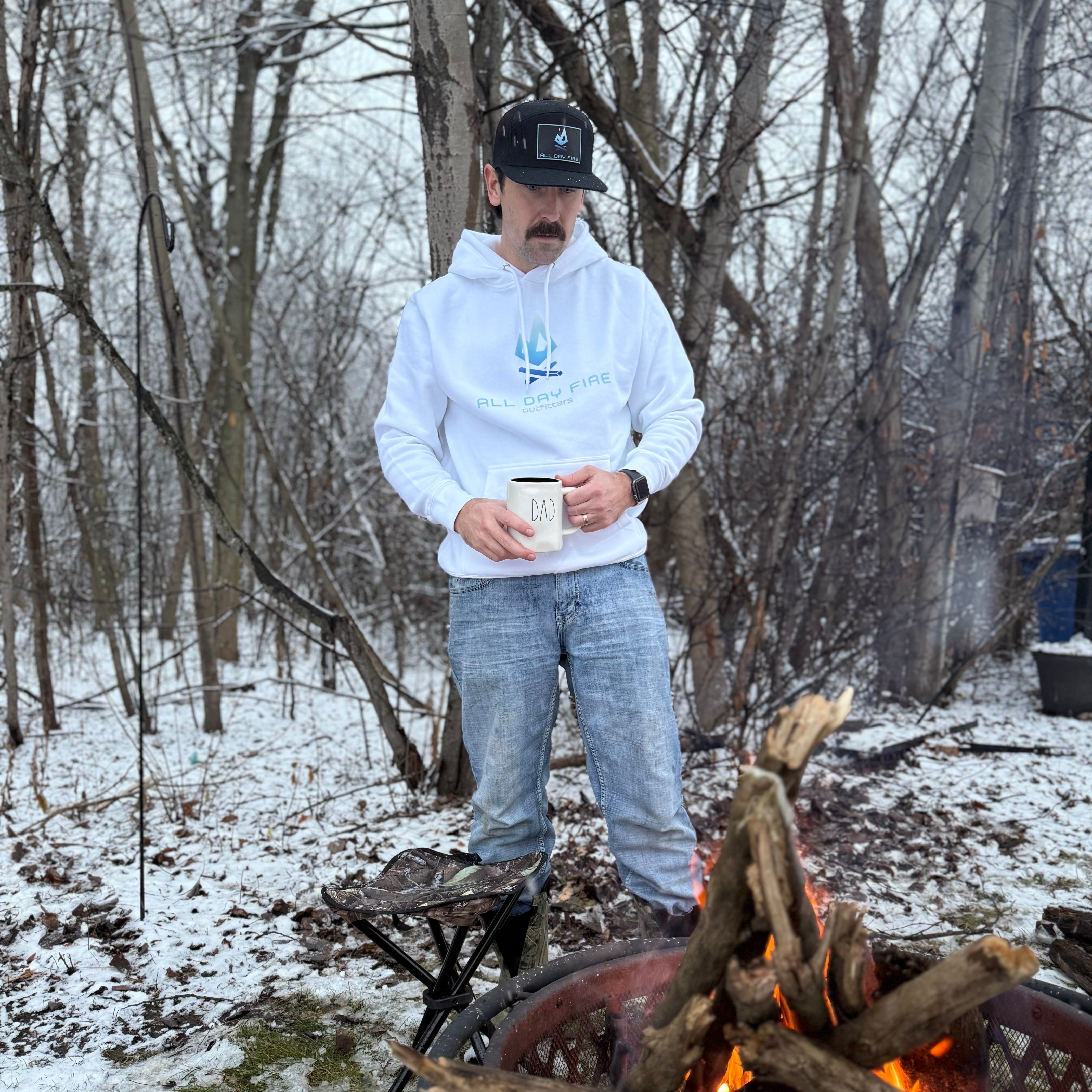 White camping hoodie with full front All Day Fire Outfitters logo. Outdoor lifestyle sweatshirt for camping and family adventures.