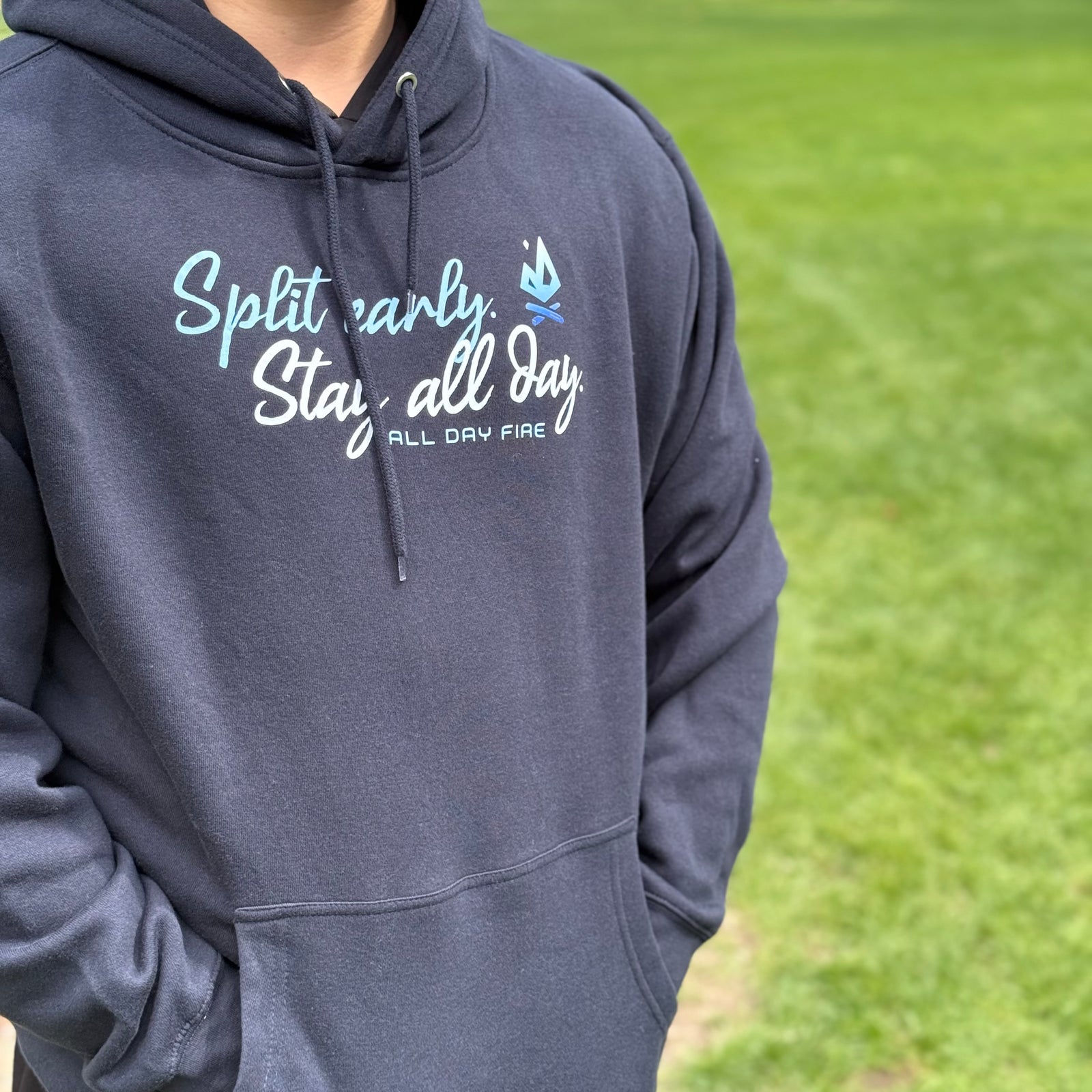 Navy hoodie with Split Early Stay All Day slogan and All Day Fire logo. Outdoor-inspired fleece hoodie for camping and everyday adventure.