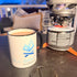 White mug with black handle featuring All Day Fire Outfitters logo. Durable ceramic mug for coffee and everyday use.