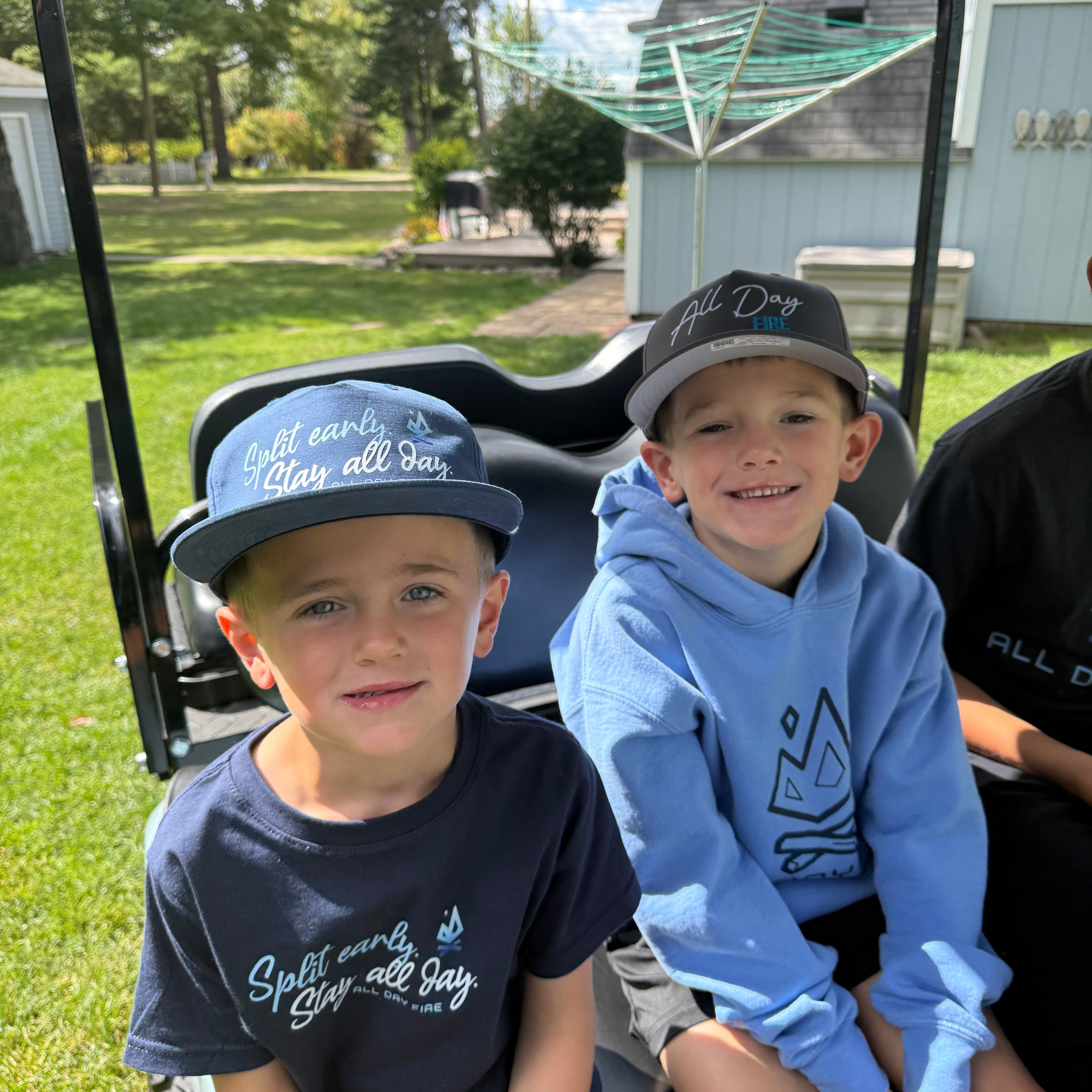 Navy and white rope-style Richardson 256 snapback featuring Split Early Stay All Day design and All Day Fire logo. Perfect for lake days and campfires.