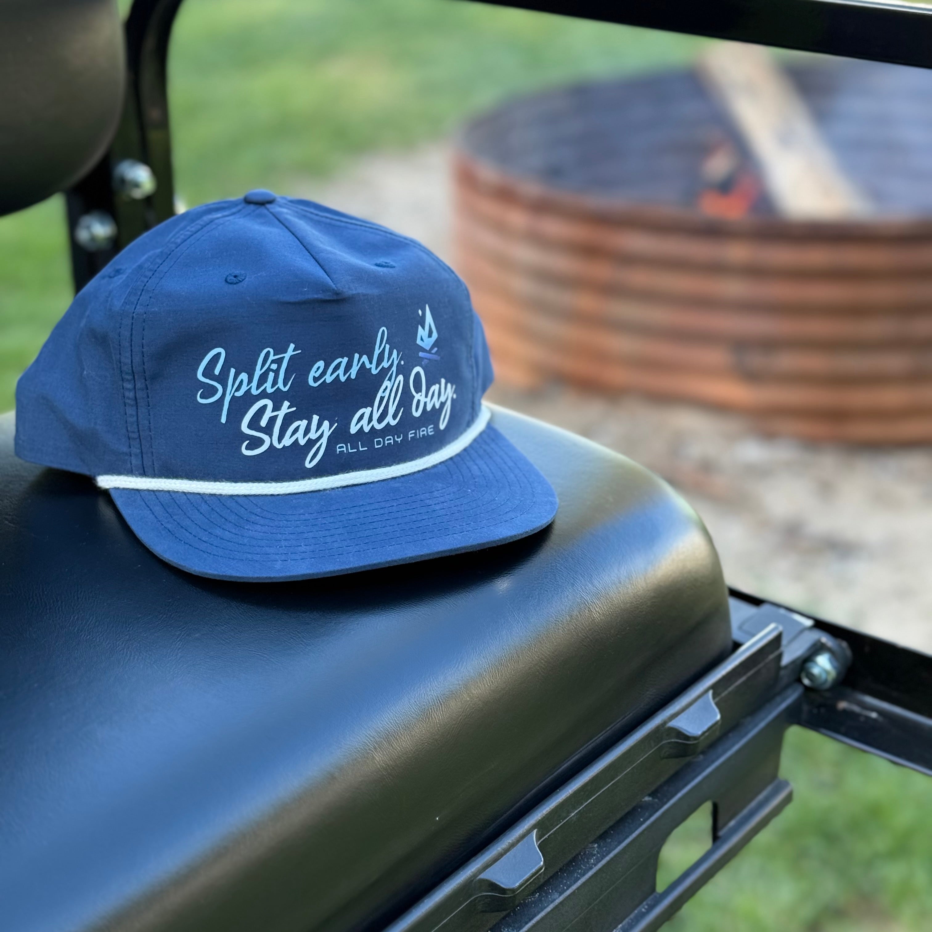 Navy and white rope-style Richardson 256 snapback featuring Split Early Stay All Day design and All Day Fire logo. Perfect for lake days and campfires.