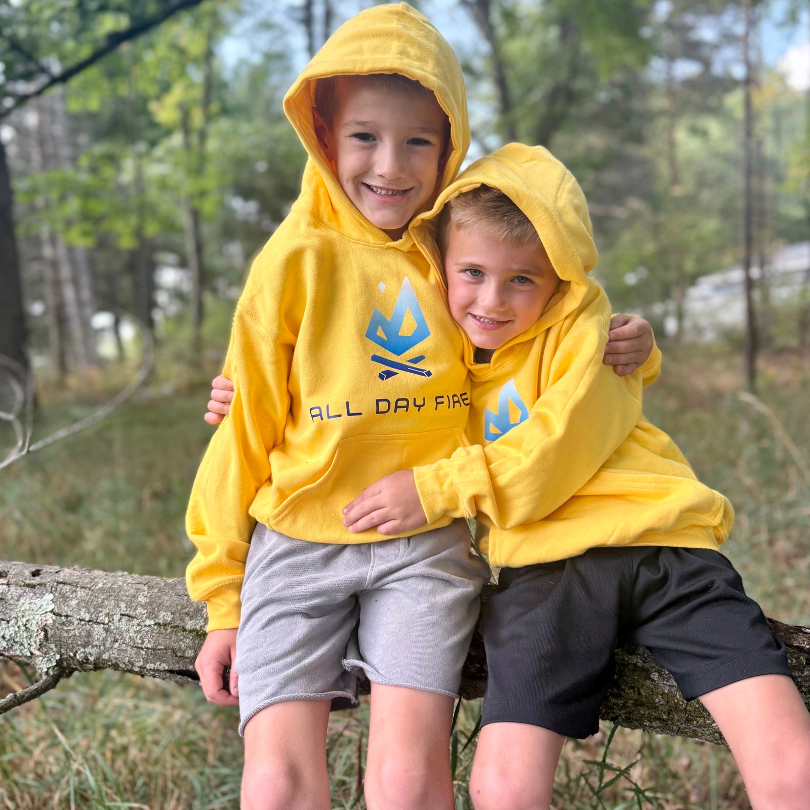 Daisy yellow youth camping hoodie with bold All Day Fire Outfitters logo on front. Soft cotton poly blend made for outdoor comfort and family adventures.