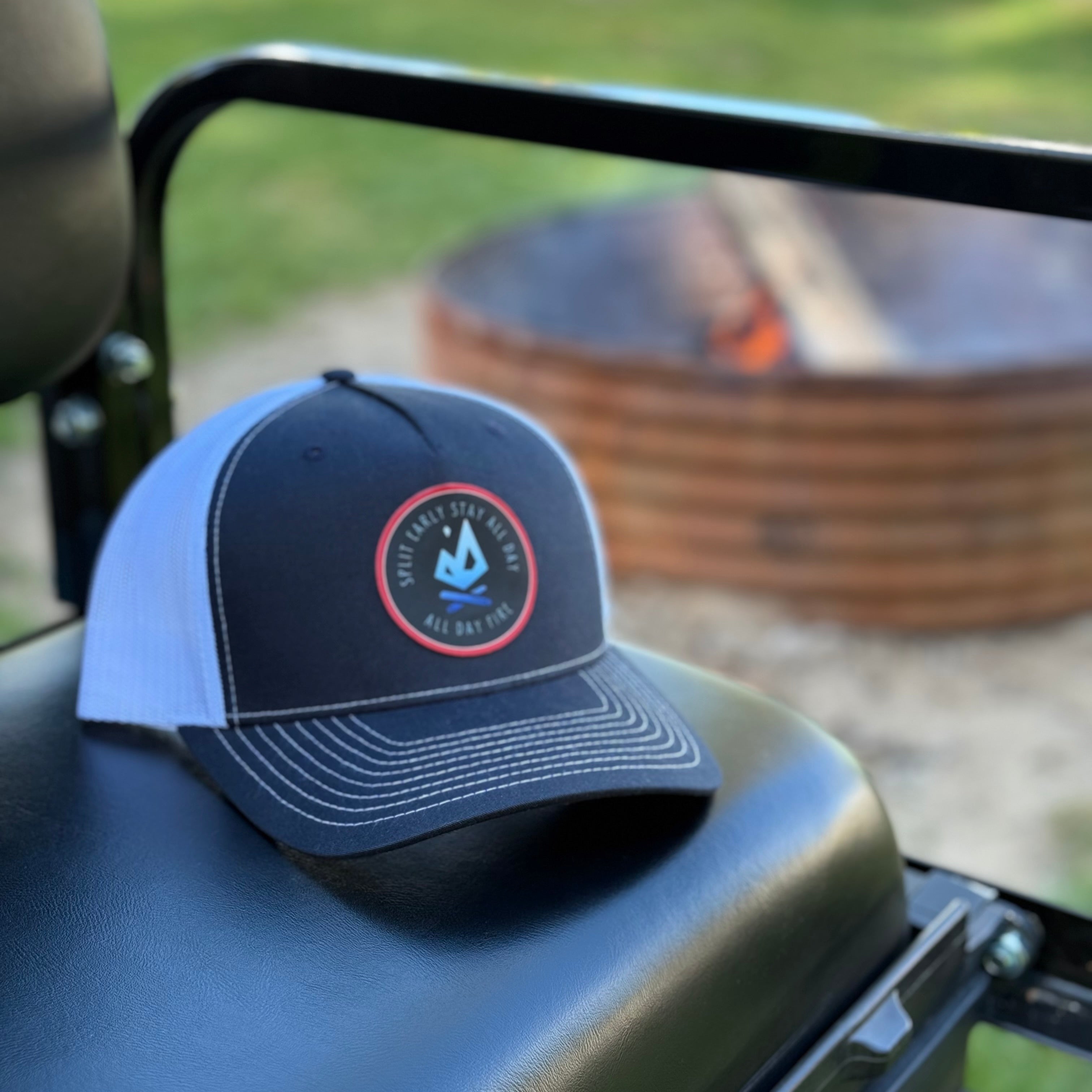 Richardson 112 5-panel black and white trucker hat with Split Early Stay All Day patch logo on front.